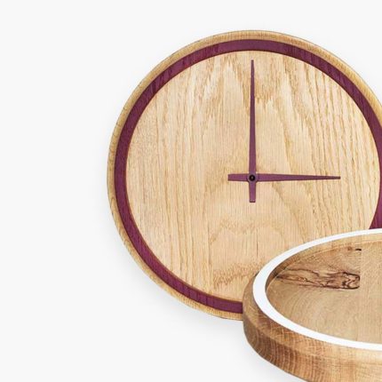 A wooden clock with red numbers on it.