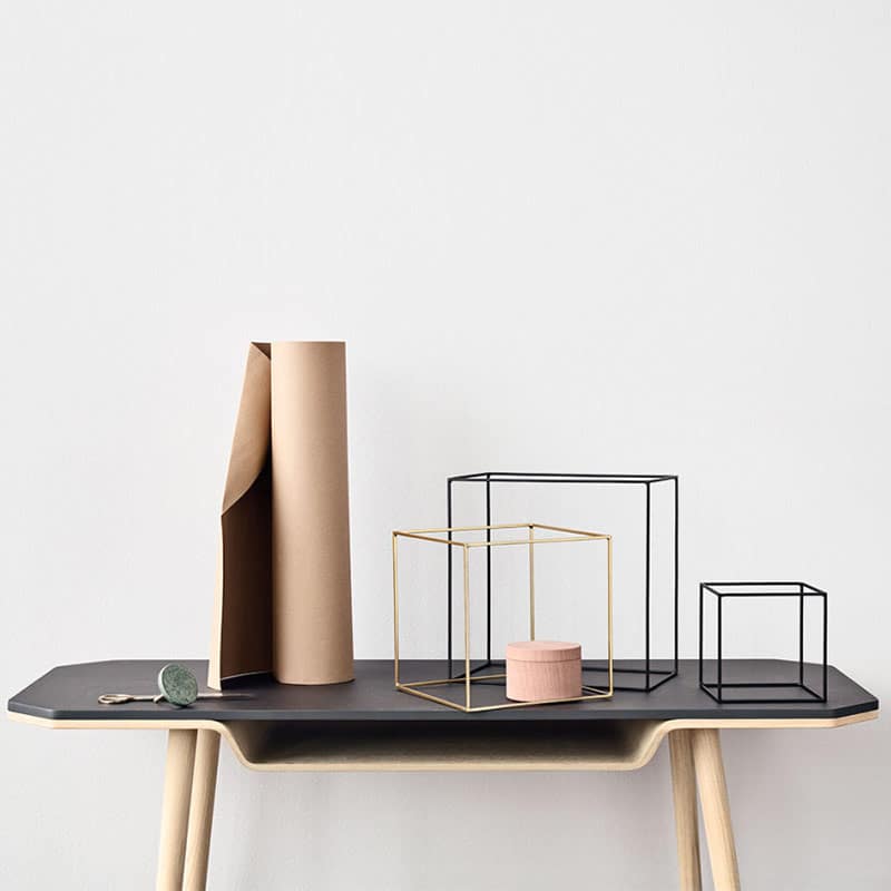 A table with some paper tubes and a candle holder
