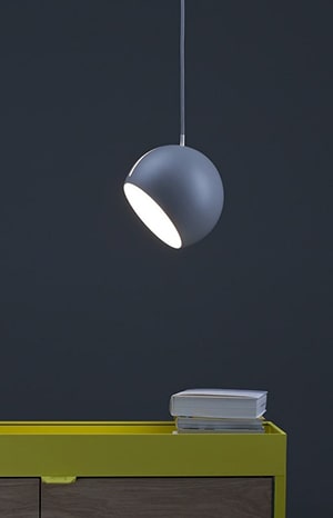 A lamp hanging from the ceiling above a table.