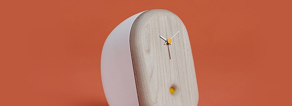 A wooden clock with yellow dot on the face.