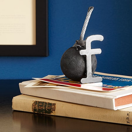 A ball and stick on top of books.