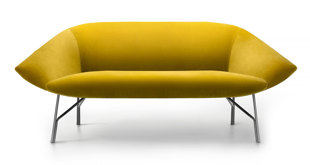 A yellow couch is sitting on the ground.