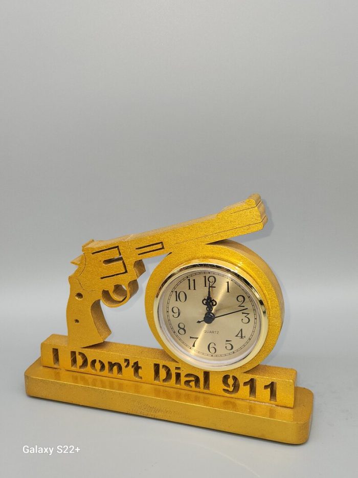 A clock that is shaped like a gun.