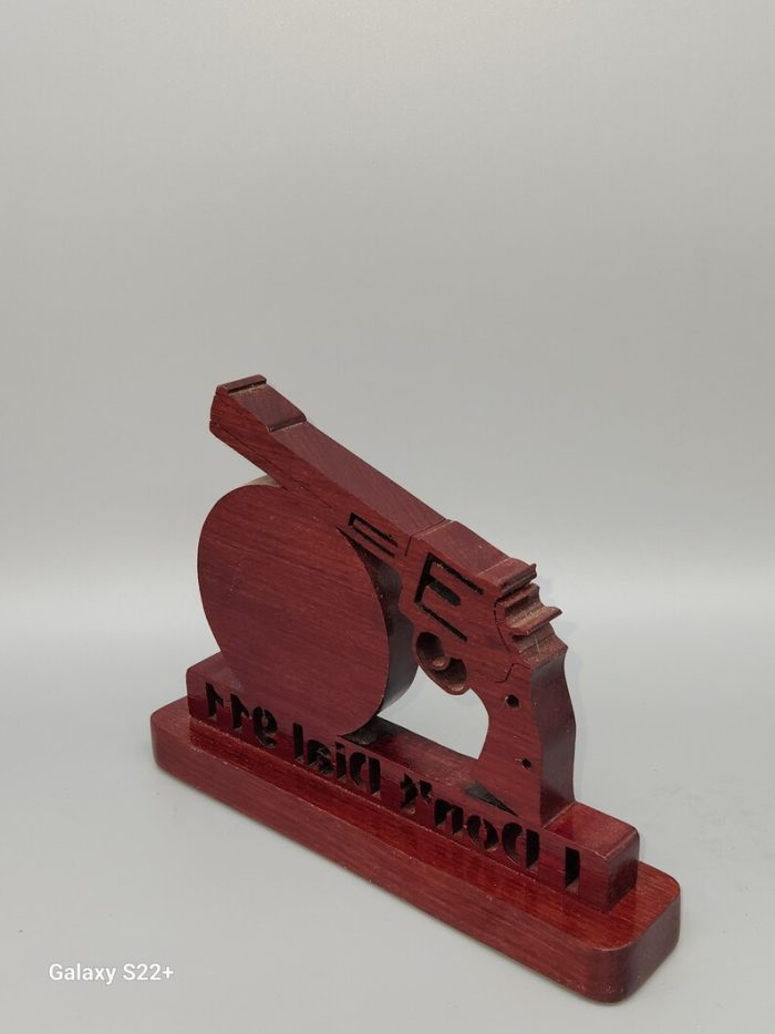 A wooden gun with the words " don 't shoot ".