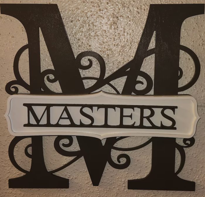 A metal sign with the word masters on it.
