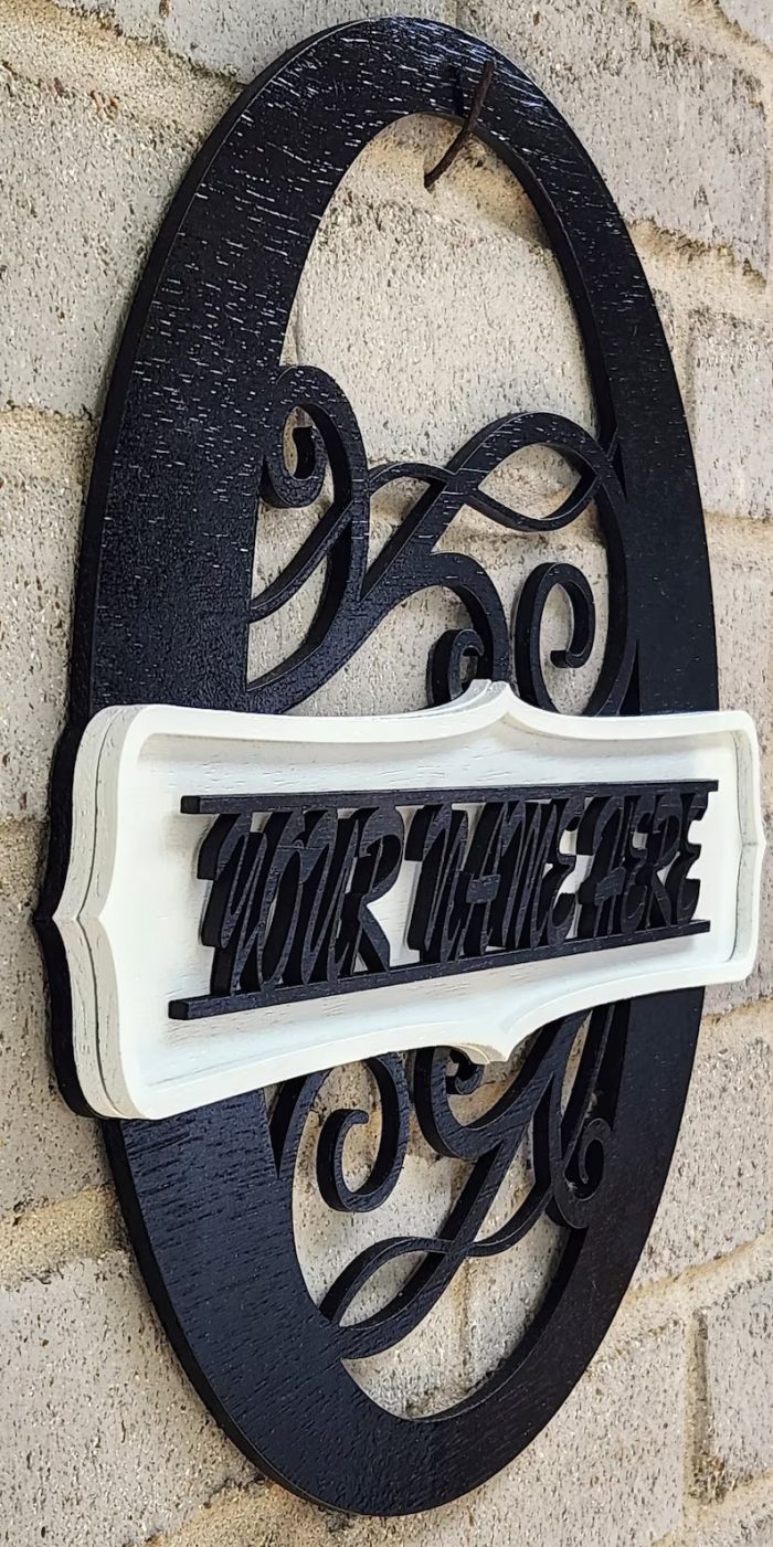 A black and white sign on the side of a building.
