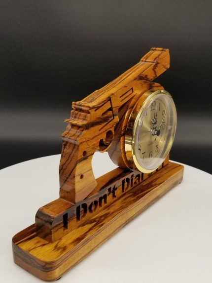 A wooden gun clock with the words " i don 't play ".