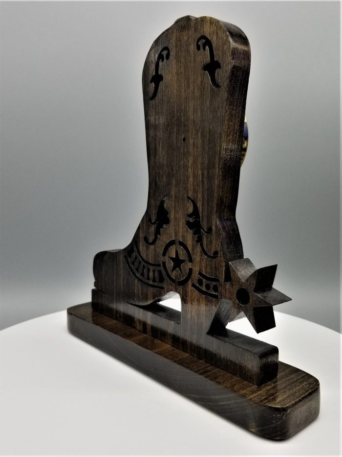 A wooden sculpture of a clock on top of a table.
