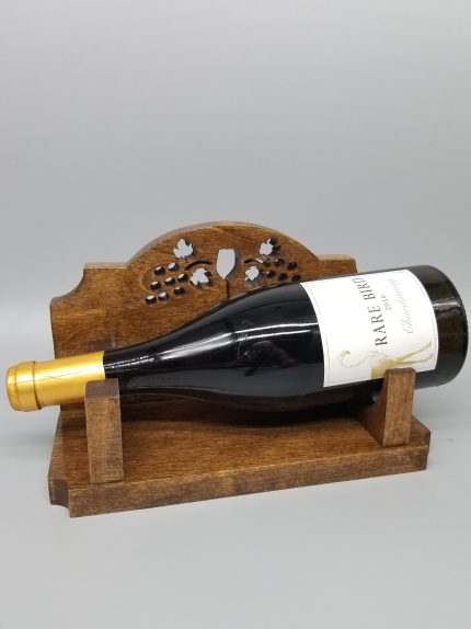 A bottle of wine is sitting on the holder.
