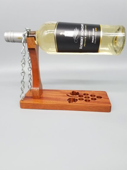A bottle of wine is attached to the side of a wooden stand.