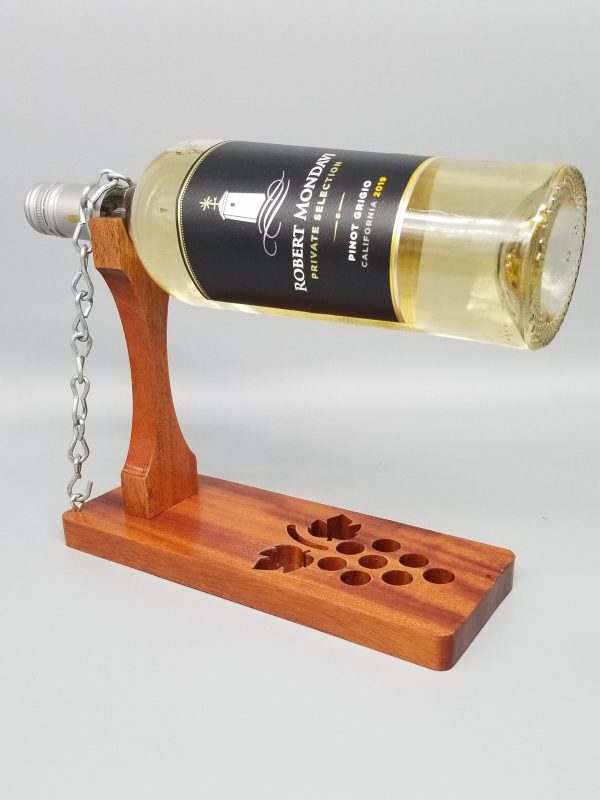 A bottle of wine is sitting on the stand.