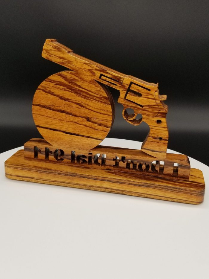 A wooden gun on top of a table.