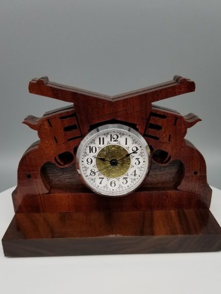 A wooden clock with a guitar design on it.