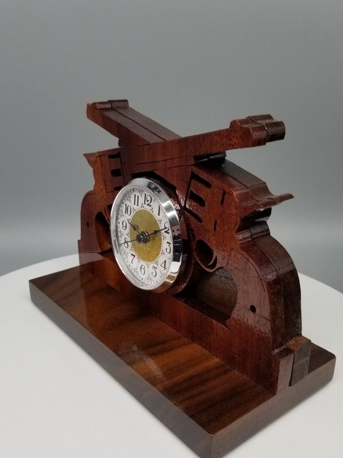 A wooden clock sitting on top of a table.