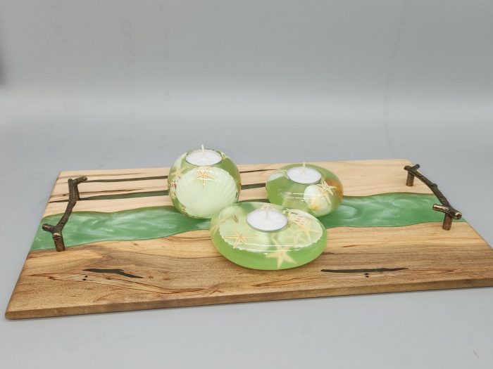 A wooden tray with candles on top of it.