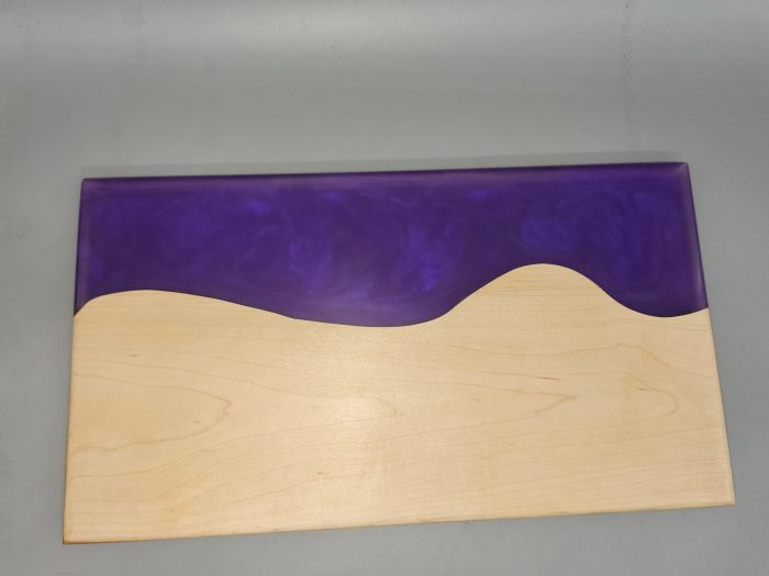 A purple and white wall with a wave on it