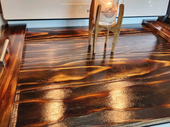 A wooden floor with some brown and orange streaks