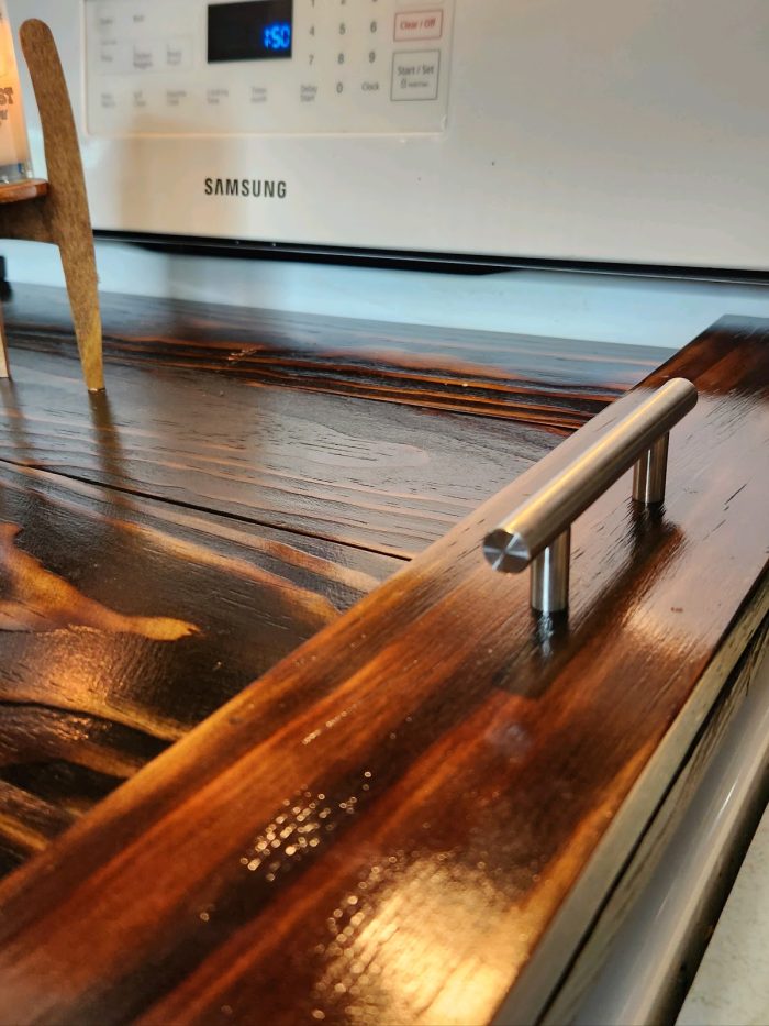 A wooden table with metal handles on it.
