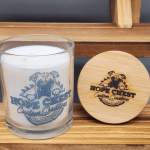 A candle and some wood on top of a table.