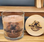 A candle sitting on top of a wooden table.