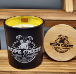 A candle sitting on top of a wooden shelf.