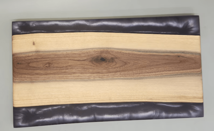 A wooden board with leather and wood on it