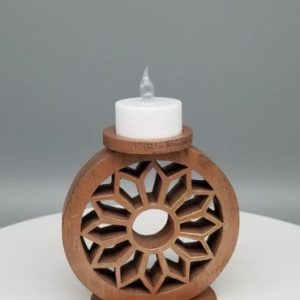 A candle holder with a candle on top of it.