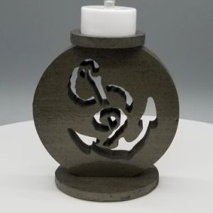 A candle holder with a design of an anchor.