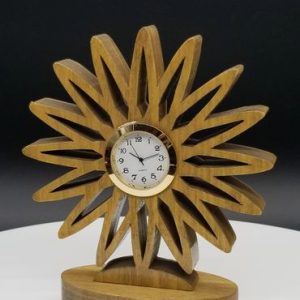 A wooden clock sitting on top of a table.