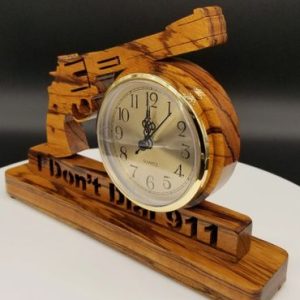 A wooden clock with the words " i don 't burn 9 1 1 ".