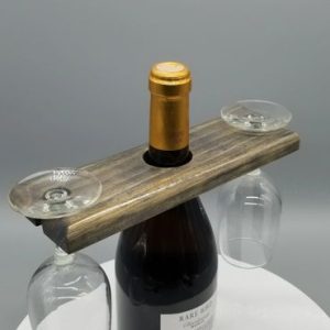 A bottle of wine and two glasses on top of a table.