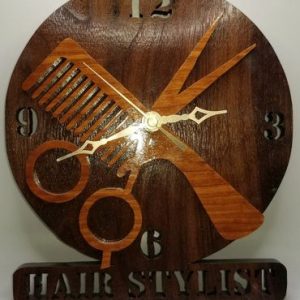 A clock with hair stylist written on it