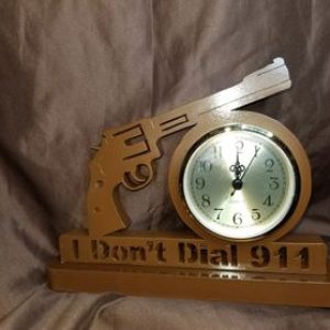 A clock with a gun on it and the words " i don 't dial 9 1 1 ".