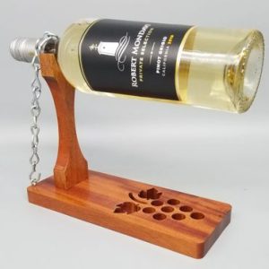 A wine bottle holder with a wooden stand.