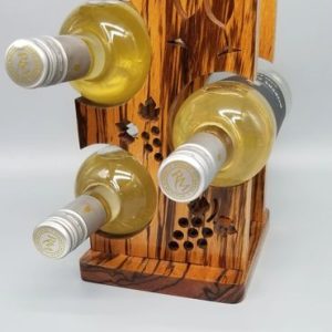 A wooden wine rack with four bottles of wine.