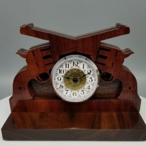 A wooden clock with a white face and a brown base.