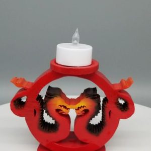 A candle holder with two birds on it