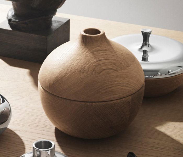 A wooden vase sitting on top of a table.